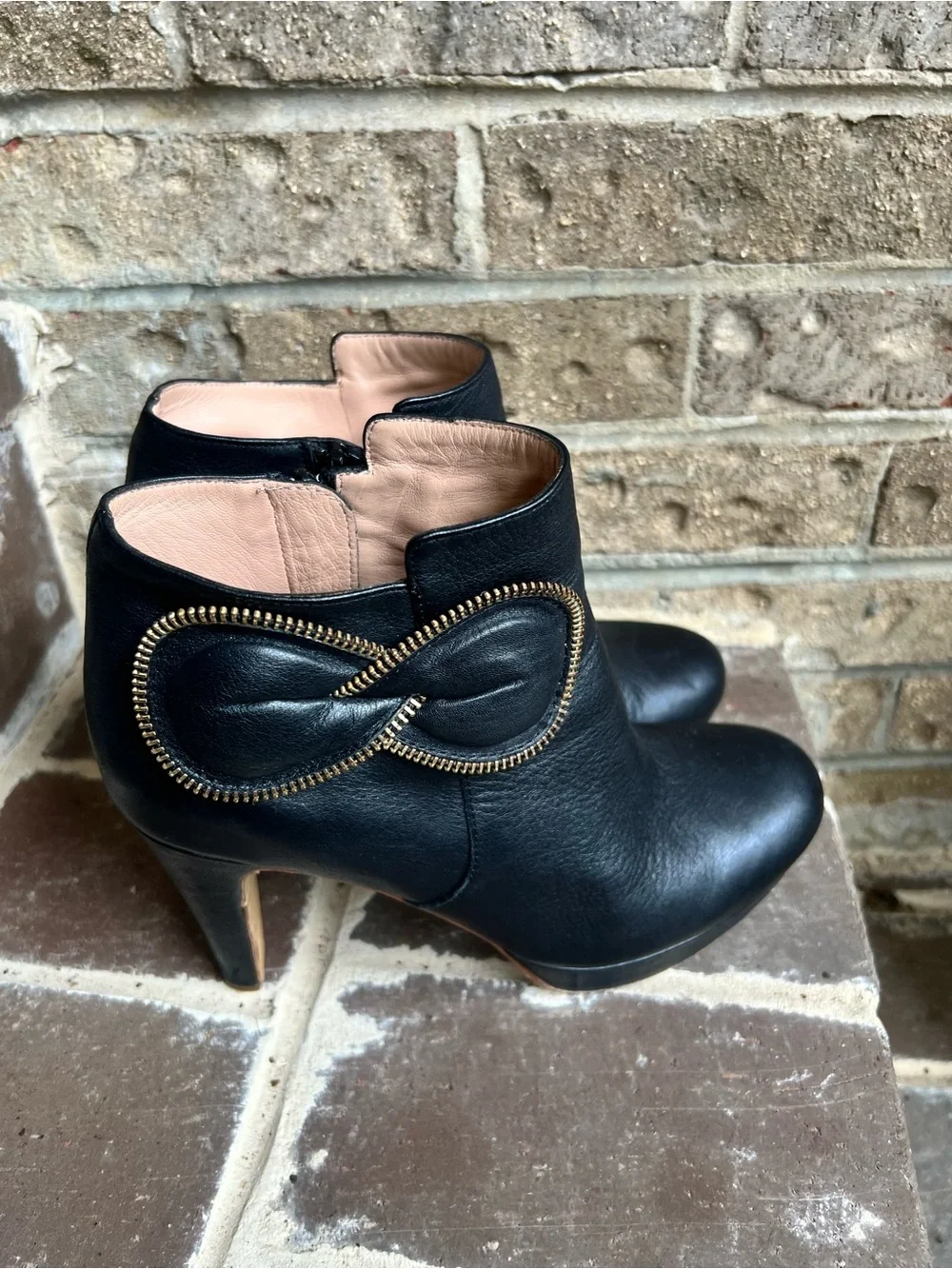 See By Chloe Black Leather Ankle Booties with Gold Zipper Bow Accent